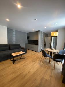 a living room with a couch and a table and chairs at Готель Поляницький in Bukovel +85 photos