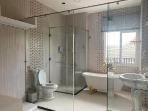 a bathroom with a tub and a toilet and a sink at Sa Villa Da Lat in Da Lat