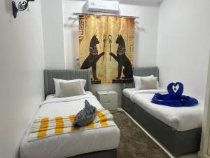 a room with two beds with towels on them at Hamed's House Luxor in Luxor +18 photos