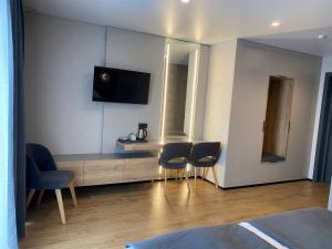 a hotel room with a table and two chairs at Готель Поляницький in Bukovel