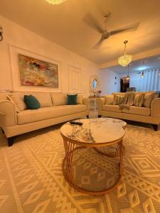 a living room with two couches and a table at Kijani Luxury Beach apartment in Malindi