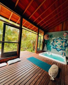 a bathroom with a jacuzzi tub on a wooden deck at Pousada Alma da Gamboa in Gamboa