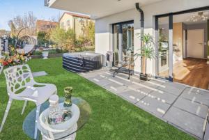 a yard with a white chair and a lawn at Luxury Long-Term Apartment with Terrace in Vienna