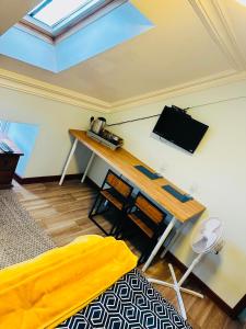 a room with a bed and a table with a television at Pisgah Guesthouse Snowdonia in Blaenau-Ffestiniog