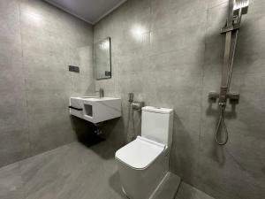 a bathroom with a toilet and a sink at Sea Tides Dhangethi in Dhangethi