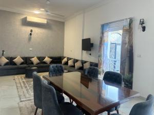 a conference room with a wooden table and chairs at Hamed's House Luxor in Luxor