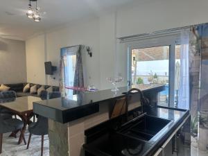 a kitchen with a sink and a living room at Hamed's House Luxor in Luxor