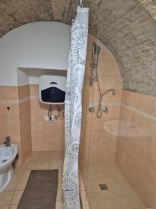 a bathroom with a shower and a sink at Sa domu pitticca Cavour in Cagliari +13 photos