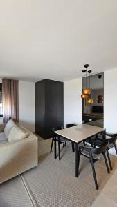 a living room with a table and a couch at Apartments DiVi Sunset View in Mandre