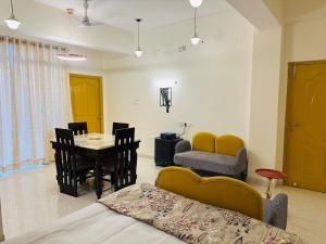 a room with a bed and a table and chairs at Pitambar in Varanasi +33 photos