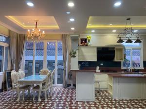a kitchen with a table and a dining room at Sa Villa Da Lat in Da Lat