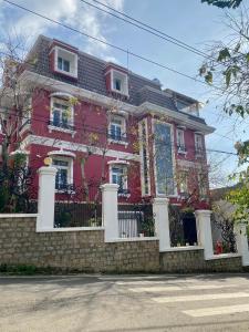 a pink house with a fence in front of it at Sa Villa Da Lat in Da Lat