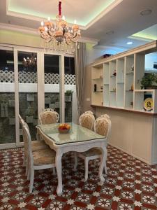 a dining room with a table and chairs and a chandelier at Sa Villa Da Lat in Da Lat +7 photos