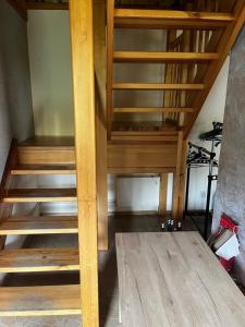 an empty room with wooden stairs in a house at Domek Sabrinka in Słajszewo +15 photos