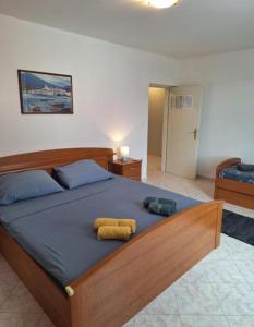 a bedroom with a bed with two towels on it at Apartments Villa Granda Tolic in Biograd na Moru