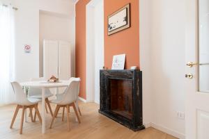 a dining room with a table and a fireplace at Il Giardinetto Guest House in Civitavecchia +33 photos