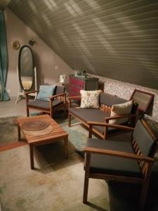 a room with couches and chairs and a table at Eliane in Le Mans