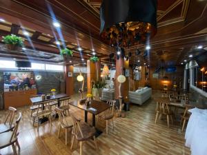 a restaurant with tables and chairs in a room at Hotel Saphir Group in Douala