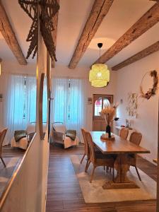 a dining room with a wooden table and chairs at L'Atypique des Remparts in Ensisheim