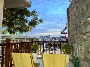 two chairs on a balcony with a view of the city at Ovana Homestay in Phan Thiet