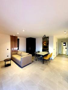 a living room with a couch and a table at Apartments DiVi Sunset View in Mandre