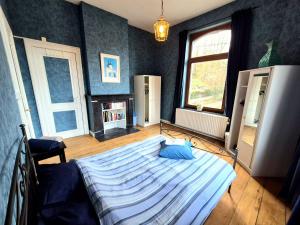 a bedroom with a large bed in a room at Maison de Maître in Liège