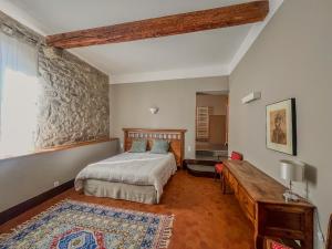 a bedroom with a bed and a table in it at Hôtel d'Alibert in Caunes-Minervois +26 photos