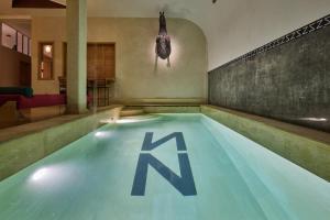a swimming pool with the letter k on the floor at Zen Zone Boutique Riad & Spa in Marrakesh