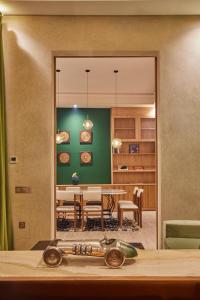 a dining room with a table and a green wall at Zen Zone Boutique Riad & Spa in Marrakesh