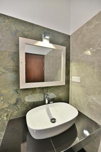 a bathroom with a white sink and a mirror at Mansion view in Unawatuna +11 photos