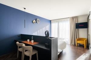 a hotel room with a bed and a table and chairs at El Cielo - Rooms with Panoramic View & El Carnicero Restaurant in Cornedo Vicentino +183 photos