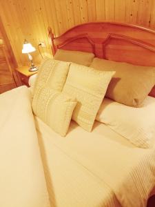 a bed with white sheets and pillows in a room at Casa MI LUCÍA in Moratalla