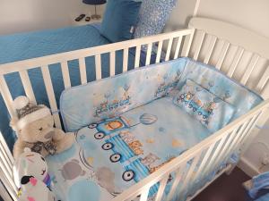 a crib with stuffed animals and a teddy bear at SEASTAR nº38 in Horta