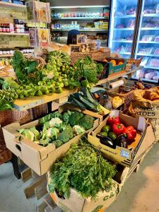 a produce section of a grocery store with boxes of vegetables at Abbey farm luxury glamping in Rhuddlan