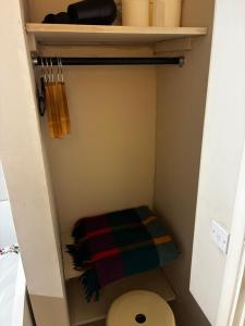 a small bathroom with a toilet and a towel at The Cozy Nook in Hanwell