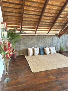 a couch sitting on a porch with pillows on it at Casa Astral in Chapada dos Guimarães
