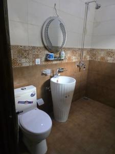 a bathroom with a toilet and a sink and a mirror at Bahria enclave sect N in Islamabad