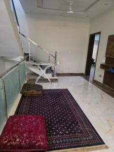 a living room with a rug on the floor at Bahria enclave sect N in Islamabad +3 photos