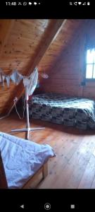 a attic room with a bed and a bed frame at Casita Walden in Cosquín