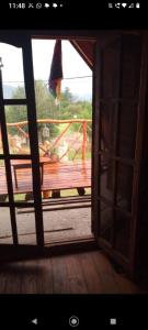 an open window with a view of a playground at Casita Walden in Cosquín +4 photos