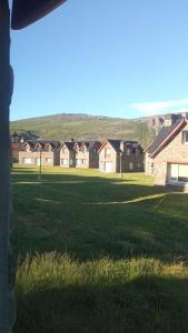 a group of houses in a field of grass at Patagonia Adriano in Caviahue