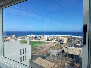 a view of a city from a window at Casa Melissa in Ponta do Sol