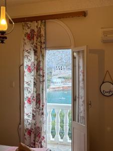 a bedroom with a window with a view of the ocean at Villa Arginonta in Kalymnos