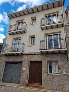a building with two balconies and two doors at Casa Guinda in Gavilanes