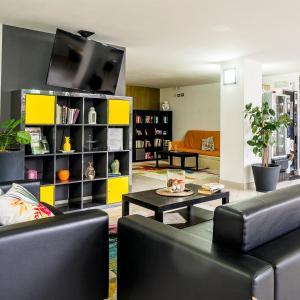 a living room with two couches and a tv at Tropicana Residence in Lido degli Estensi +55 photos