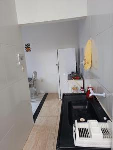 a small kitchen with a sink and a stove at Studio Com Ar Condicionado na Manoel Novais in Serrinha +17 photos