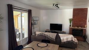 a living room with a bed and a table at Mare è Muntagna in Mignataja