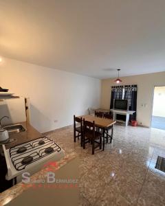 a kitchen and living room with a table and a stove at Departamento del Tuyu in Mar del Tuyú +5 photos