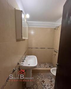 a bathroom with a sink and a toilet at Departamento del Tuyu in Mar del Tuyú