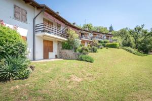 a house with a yard in front of it at VISTA BELLA am Gardasee in San Zeno di Montagna